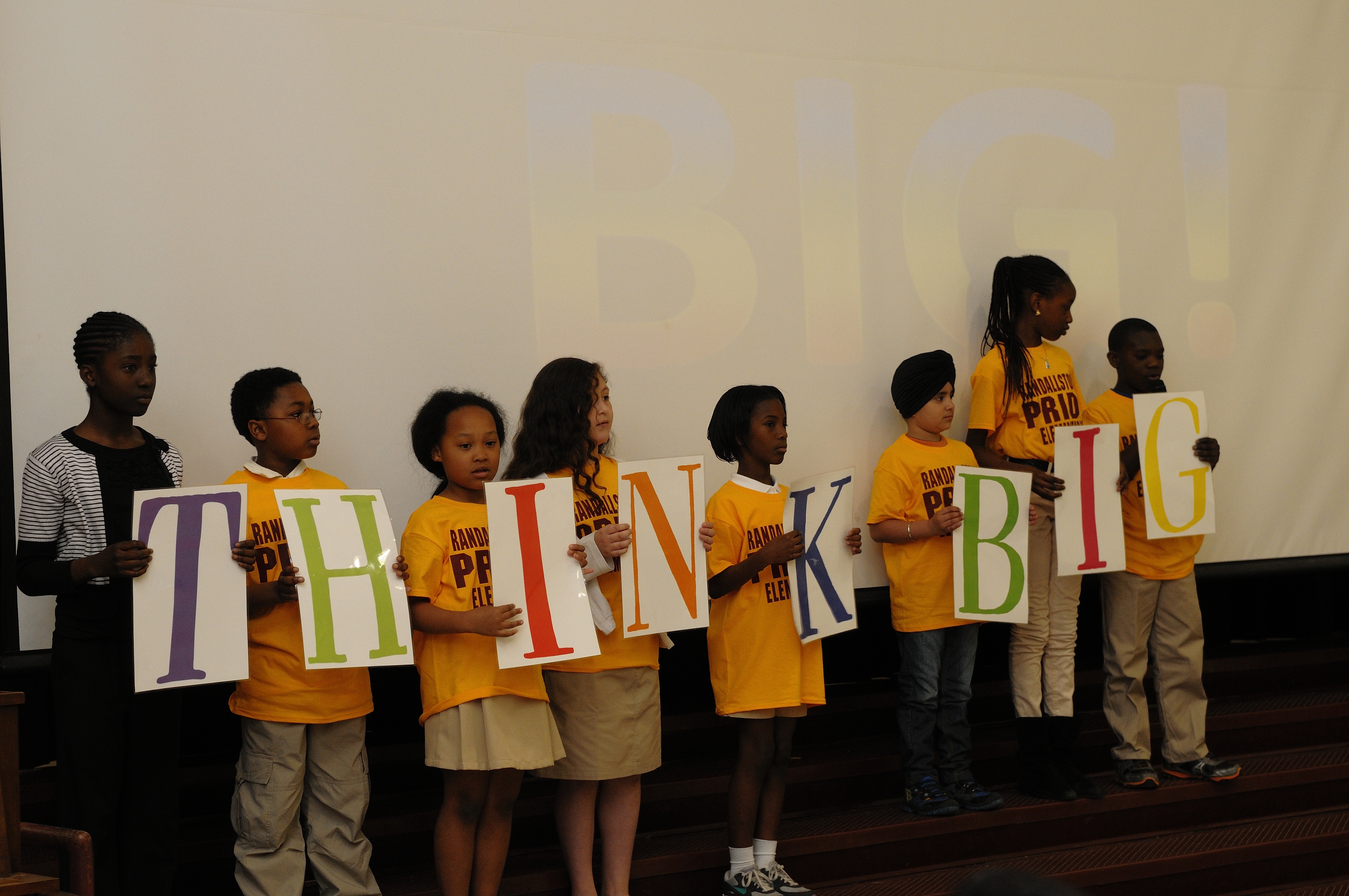 students holding THINK BIG sign