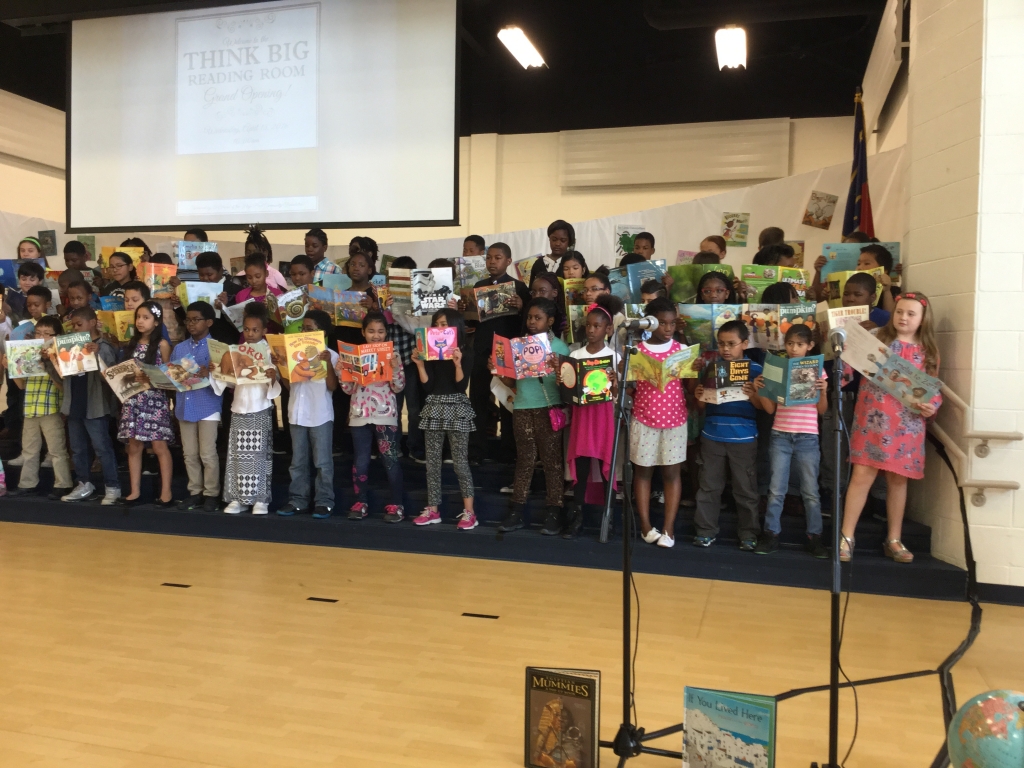 children-holding-books-on-stage